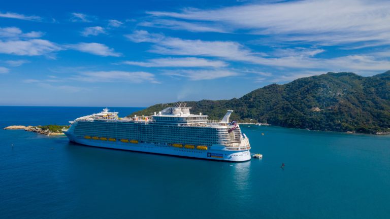 white cruise ship - retired couple enjoying a scenic view from a cruise ship, exploring the best cruises for seniors