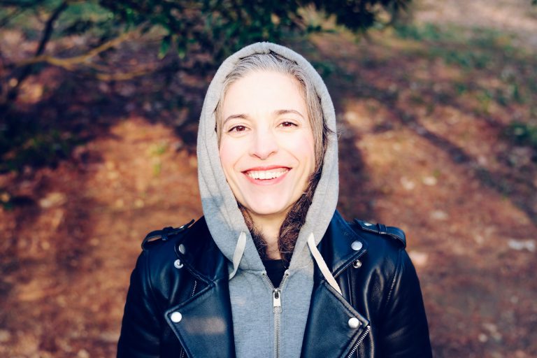 woman smiling near tree - A retiree enjoying early retirement in the UK, exploring strategies for financial independence and lifestyle planning.