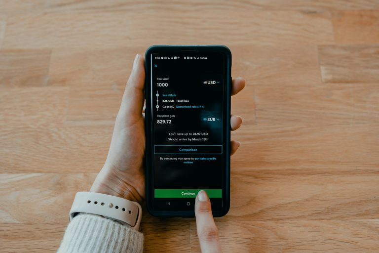 person holding black samsung android smartphone - A retiree evaluating pension transfer options, weighing the pros and cons of moving their retirement savings