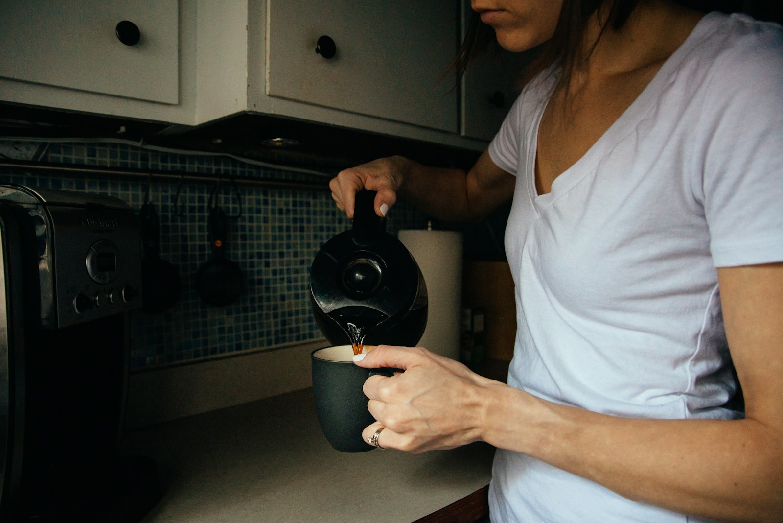 woman in white v neck t-shirt holding black round device. A retiree following a balanced daily routine, including hobbies, social activities, and relaxation